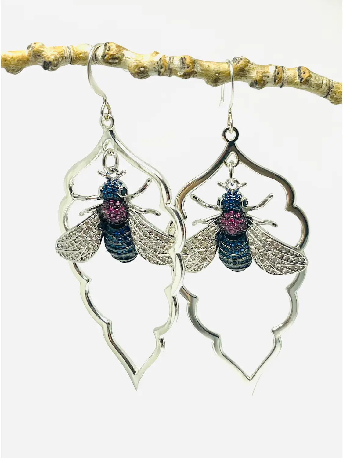 Arabesque Bee Earrings Arabesque Bee Earrings - micro-pavé bee in sapphire blue and fuchsia inside a silver-plated arabesque frame, by My36Breaths