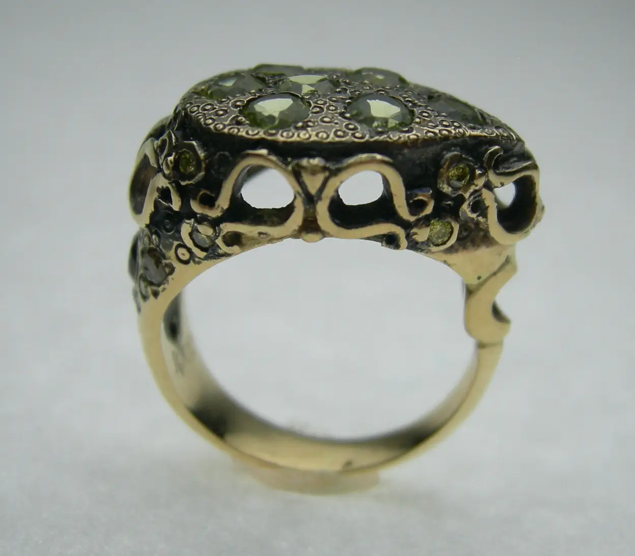 The Heartseed Ring — 14kt gold teardrop dome set with seven peridots, yellow and chocolate diamonds and garnet