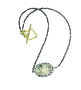 Rutilated Quartz Oval Drop, CZ bezel set, 2mm pyrite beads and 14kt Vermeil clasp. Necklace 16" Rutilated Quartz, CZ bezel set, 2mm pyrite beads and 14kt Vermeil clasp